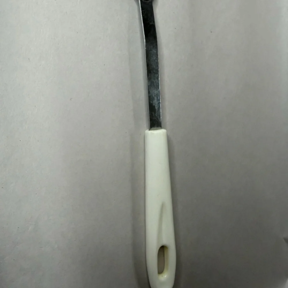 Elegant Slotted Spoon with Cream Handle